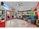 The living room offers a ceiling fan, a large flat-screen television, and sliding door access to the outside at 6241 Colony Cir, Weeki Wachee, FL 34607