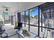 Relaxing screened-in porch with ceiling fan, outdoor furniture, and a view of the beautiful yard at 6241 Colony Cir, Weeki Wachee, FL 34607