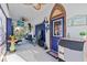 Inviting covered front porch with ice machine, ceiling fans, furniture, and a whimsical beachy decor at 6241 Colony Cir, Weeki Wachee, FL 34607