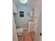 Bathroom with a white vanity, and beach themed curtain and decor at 6737 Clark St, Hudson, FL 34667