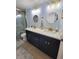 Beautiful bathroom with double vanity, granite counters, gold hardware, and tiled shower at 6737 Clark St, Hudson, FL 34667
