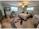 Cozy bedroom features a ceiling fan, natural light, and seaside decorations at 6737 Clark St, Hudson, FL 34667