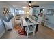 Open-concept dining room featuring a long table, tropical rug, and stylish decorations with coastal-inspired decor at 6737 Clark St, Hudson, FL 34667