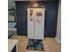 Full kitchen pantry and refrigerator with storage, matching cabinets and nautical decoration at 6737 Clark St, Hudson, FL 34667