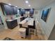Well-equipped kitchen with navy cabinets, modern appliances, an island with seating, and nautical decorations at 6737 Clark St, Hudson, FL 34667