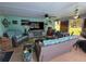 Cozy sunroom with comfortable seating, ceiling fan, and views of the lush outdoors at 6737 Clark St, Hudson, FL 34667