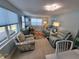 Comfortable living room with lots of light, coastal decor and a tropical rug to brighten the space at 6737 Clark St, Hudson, FL 34667