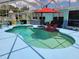 Inviting in-ground pool with an umbrella, a hot tub, and lounge chairs for relaxation and outdoor enjoyment at 6737 Clark St, Hudson, FL 34667