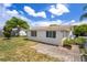 This home has a spacious backyard with a small patio and tropical landscaping at 6930 El Camino Paloma St, Port Richey, FL 34668
