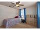 Bedroom features a ceiling fan and is currently being used for storage and moving boxes at 6930 El Camino Paloma St, Port Richey, FL 34668
