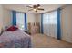Functional bedroom with a ceiling fan, boxes, and large window for natural light at 6930 El Camino Paloma St, Port Richey, FL 34668