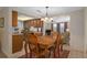 Inviting dining room features a wooden table with seating for four and decorative lighting at 6930 El Camino Paloma St, Port Richey, FL 34668