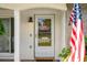 Detailed view of the front door with glass panel and stone wall at 6930 El Camino Paloma St, Port Richey, FL 34668
