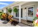 Close-up of the front porch with decorative plants and tiled flooring at 6930 El Camino Paloma St, Port Richey, FL 34668