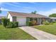 Well-maintained front yard showcasing the home's stone facade and manicured landscaping at 6930 El Camino Paloma St, Port Richey, FL 34668