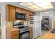 A well-equipped kitchen featuring wood cabinets and modern stainless steel appliances at 6930 El Camino Paloma St, Port Richey, FL 34668