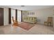 Bright living room featuring a comfortable sofa and neutral wall color at 6930 El Camino Paloma St, Port Richey, FL 34668