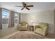 Bright seating area with tile floors, ceiling fan, and ample natural light at 6930 El Camino Paloma St, Port Richey, FL 34668