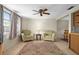 Comfortable seating area with ceiling fan, tile floors, and a cozy atmosphere at 6930 El Camino Paloma St, Port Richey, FL 34668