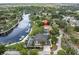 Drone shot showcases the waterfront property's layout including a pool, boat dock, and lush landscaping at 6936 River Rd, New Port Richey, FL 34652