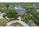 Stunning waterfront home featuring lush landscaping, circular driveway, and tranquil views at 6936 River Rd, New Port Richey, FL 34652