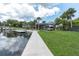 Beautiful waterfront backyard featuring a dock, boat lift, and a scenic view of the water at 6936 River Rd, New Port Richey, FL 34652