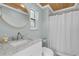Elegant bathroom featuring marble countertops, modern fixtures, and a shower with a curtain at 6936 River Rd, New Port Richey, FL 34652