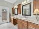Bathroom with double vanities, granite countertop and framed mirrors at 6936 River Rd, New Port Richey, FL 34652