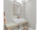 A minimalist powder room with a vessel sink, rustic wood vanity, and modern lighting at 6936 River Rd, New Port Richey, FL 34652