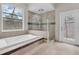 Bathroom showcasing a soaking tub, glass shower and tile floors at 6936 River Rd, New Port Richey, FL 34652