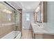 Bright bathroom showcasing a glass-enclosed shower and dual sink vanity at 6936 River Rd, New Port Richey, FL 34652