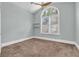 Bedroom featuring a large window, shutters and vaulted ceilings at 6936 River Rd, New Port Richey, FL 34652