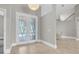 Bright foyer showcasing decorative glass doors, tile flooring, and an open staircase at 6936 River Rd, New Port Richey, FL 34652