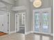 Bright foyer with decorative glass front doors, tile floors and neutral paint palette at 6936 River Rd, New Port Richey, FL 34652