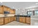 Well-equipped kitchen with stainless steel appliances, tile flooring, and custom wood cabinetry at 6936 River Rd, New Port Richey, FL 34652