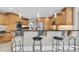 Gourmet kitchen with wood cabinetry, granite countertops, and stainless steel appliances at 6936 River Rd, New Port Richey, FL 34652