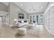 Bright and airy living room with high ceilings, tile floors, and access to outdoor space at 6936 River Rd, New Port Richey, FL 34652