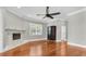 Living room featuring a stone fireplace, hardwood floors and a ceiling fan at 6936 River Rd, New Port Richey, FL 34652