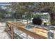 Outdoor kitchen with sink and grill under a vine-covered pergola, perfect for entertaining by the pool at 6936 River Rd, New Port Richey, FL 34652