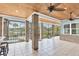 Spacious screened porch with brick columns, tile flooring, and lake views at 6936 River Rd, New Port Richey, FL 34652