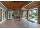 Gorgeous screened porch with brick pillars, outdoor seating, pool and lake view at 6936 River Rd, New Port Richey, FL 34652
