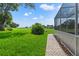 Well-maintained backyard with brick pathway, verdant lawn, and views of the golf course at 7328 Blue Skies Dr, Spring Hill, FL 34606