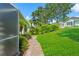 Manicured backyard featuring lush landscaping, a brick path, and tranquil surroundings at 7328 Blue Skies Dr, Spring Hill, FL 34606