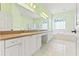 Bathroom with double sink vanity and decorative windows at 7328 Blue Skies Dr, Spring Hill, FL 34606