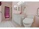 This bathroom includes an updated toilet, vanity with ample cabinet space, and a walk-in shower at 7328 Blue Skies Dr, Spring Hill, FL 34606