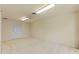 A spacious room with a ceiling fan, neutral carpet, and a closet with folding doors at 7328 Blue Skies Dr, Spring Hill, FL 34606