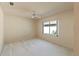 Carpeted room with a ceiling fan and a window with a view of the landscaping at 7328 Blue Skies Dr, Spring Hill, FL 34606