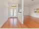 Open foyer features hardwood flooring, decorative glass doors, and an open view to a bright living space at 7328 Blue Skies Dr, Spring Hill, FL 34606
