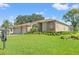 Beautiful one-story home showcases lush landscaping, a brick-accented facade, and a well-kept lawn at 7328 Blue Skies Dr, Spring Hill, FL 34606