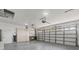 Well-lit three car garage featuring storage cabinets and workbench, offering functionality and organization at 7328 Blue Skies Dr, Spring Hill, FL 34606